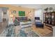Comfortable living room with neutral-toned sofa and a colorful accent rug at 6913 8Th W Ave, Bradenton, FL 34209