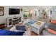 Open concept living room flows to dining area, featuring neutral decor and wood floors at 6913 8Th W Ave, Bradenton, FL 34209