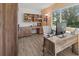 Bright home office featuring a modern desk, chair, and shelves, filled with natural light from the large window at 6913 8Th W Ave, Bradenton, FL 34209