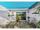 Relaxing outdoor patio under a blue sunshade, furnished with comfortable seating and a barbecue grill at 6913 8Th W Ave, Bradenton, FL 34209