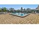 Community pool with a brick surround and pool side furniture at 6913 8Th W Ave, Bradenton, FL 34209