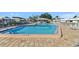 Community pool with shallow end and pool side furniture at 6913 8Th W Ave, Bradenton, FL 34209
