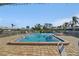 Community pool with shallow end and pool side furniture at 6913 8Th W Ave, Bradenton, FL 34209