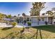 Single-story home with gray siding, white trim, and landscaped yard at 711 Coquina Ct, Nokomis, FL 34275