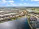 Aerial view of homes situated on lakefront property in gated community at 7130 Whittlebury Trl, Bradenton, FL 34202