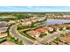 An aerial perspective of the community, including homes, streets, and surrounding greenery at 7130 Whittlebury Trl, Bradenton, FL 34202