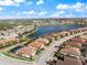 Aerial view of home with screened pool and lake view in beautiful community at 7130 Whittlebury Trl, Bradenton, FL 34202