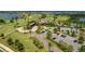 An aerial shot showcases the clubhouse, surrounded by palm trees and manicured landscaping at 7130 Whittlebury Trl, Bradenton, FL 34202