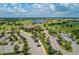 Aerial view of the clubhouse, parking lot, and golf course in a beautiful community at 7130 Whittlebury Trl, Bradenton, FL 34202