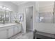 A bathroom featuring a gray vanity with modern fixtures, a gray tiled shower and a comfortable bench at 7130 Whittlebury Trl, Bradenton, FL 34202