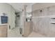 This bathroom showcases a glass shower, gray tile and modern fixtures, and a bench outside the shower at 7130 Whittlebury Trl, Bradenton, FL 34202