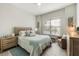 Charming bedroom with a comfortable bed, soft lighting, and a cozy seating area at 7130 Whittlebury Trl, Bradenton, FL 34202