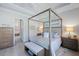 Elegant bedroom with a luxurious canopy bed, soft lighting, and serene decor, creating a cozy and inviting atmosphere at 7130 Whittlebury Trl, Bradenton, FL 34202