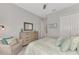 Charming bedroom features a stylish dresser, comfortable chair and calming coastal decor at 7130 Whittlebury Trl, Bradenton, FL 34202