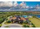 Aerial view of the community clubhouse with pool and golf course in the background at 7130 Whittlebury Trl, Bradenton, FL 34202