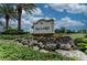 Community entrance sign surrounded by lush greenery, flowers, and landscaping at 7130 Whittlebury Trl, Bradenton, FL 34202