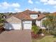 Aerial view of home with three-car garage, tile roof, and stone accents at 7130 Whittlebury Trl, Bradenton, FL 34202