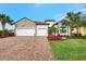 Beautiful home with a three-car garage, well-manicured lawn, and gorgeous landscaping at 7130 Whittlebury Trl, Bradenton, FL 34202