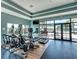 Well-equipped gym with treadmills, elliptical machines, and floor to ceiling windows at 7130 Whittlebury Trl, Bradenton, FL 34202