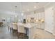 Bright kitchen featuring a large central island with bar seating and white cabinetry at 7130 Whittlebury Trl, Bradenton, FL 34202
