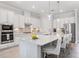 Well-lit kitchen showcases stainless steel appliances, quartz countertops, and a spacious island at 7130 Whittlebury Trl, Bradenton, FL 34202