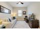 Cozy living room with a comfortable sofa, modern desk, and ample natural light at 7130 Whittlebury Trl, Bradenton, FL 34202