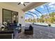 Covered patio with comfortable seating and a clear view of the pool and screened-in lanai at 7130 Whittlebury Trl, Bradenton, FL 34202