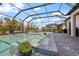 Stunning screened-in pool with integrated spa and sun loungers, perfect for outdoor relaxation and entertaining in style at 7130 Whittlebury Trl, Bradenton, FL 34202