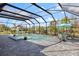 Beautiful screened-in pool area with a dining table, perfect for entertaining and enjoying the outdoors at 7130 Whittlebury Trl, Bradenton, FL 34202