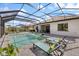Lovely screened-in pool with inviting chaise lounges and a dining area, perfect for relaxation and outdoor entertainment at 7130 Whittlebury Trl, Bradenton, FL 34202