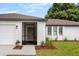 White brick house with brown roof, screened porch entry and landscaping at 722 Sailfish Dr, Brandon, FL 33511