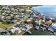 Aerial view of homes, with waterfront access, showcasing neighborhood and damaged properties at 806 Arlington Rd, Palmetto, FL 34221