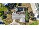 Aerial view of home with screened pool, concrete driveway, and well-maintained landscaping at 806 Arlington Rd, Palmetto, FL 34221