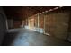 Unfinished basement featuring exposed framework with plywood and concrete block walls at 806 Arlington Rd, Palmetto, FL 34221