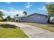 Beautiful single-story home with attached garage, lush lawn and concrete driveway at 806 Arlington Rd, Palmetto, FL 34221