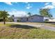 Charming single-story home with a well-manicured lawn and mature palm trees at 806 Arlington Rd, Palmetto, FL 34221