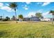 Inviting single-story home with a lush green lawn and a spacious driveway at 806 Arlington Rd, Palmetto, FL 34221