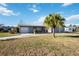 Front exterior view of a one-story home with attached garage and landscaping at 806 Arlington Rd, Palmetto, FL 34221