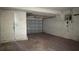 Spacious garage featuring overhead door, utility door and electrical panel at 806 Arlington Rd, Palmetto, FL 34221