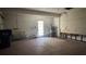 Unfinished garage with a utility sink, door to the yard, and water heater at 806 Arlington Rd, Palmetto, FL 34221