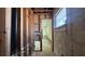 Hallway exposing framing and plumbing, with a window at 806 Arlington Rd, Palmetto, FL 34221