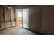 Living room space exposing wall insulation and a glass sliding door at 806 Arlington Rd, Palmetto, FL 34221