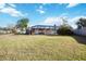Screened-in pool and spacious backyard with a wooden fence at 806 Arlington Rd, Palmetto, FL 34221