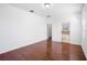 Main bedroom with wood-look laminate flooring, ensuite bathroom, and a walk-in closet at 8332 Karpeal Dr, Sarasota, FL 34238