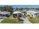 Aerial view of a mobile home with landscaped yard and driveway at 8411 Regal Way, Palmetto, FL 34221