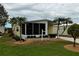Well-maintained home featuring a covered front porch and lush landscaping at 8411 Regal Way, Palmetto, FL 34221