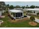 Lovely home featuring mature trees, a nice front yard, and beautiful landscaping at 8411 Regal Way, Palmetto, FL 34221