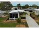 Well-kept exterior with palm trees, meticulous landscaping and a spacious driveway at 8411 Regal Way, Palmetto, FL 34221
