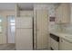 Compact kitchen with essential appliances, ample storage, and a door to the exterior at 8411 Regal Way, Palmetto, FL 34221