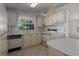 Kitchen featuring white cabinetry, ample counter space, and essential appliances at 8411 Regal Way, Palmetto, FL 34221